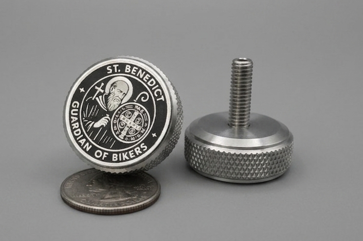 'Guardian of Bikers' motorcycle part featuring an engraved St. Benedict medal.harley seat bolt